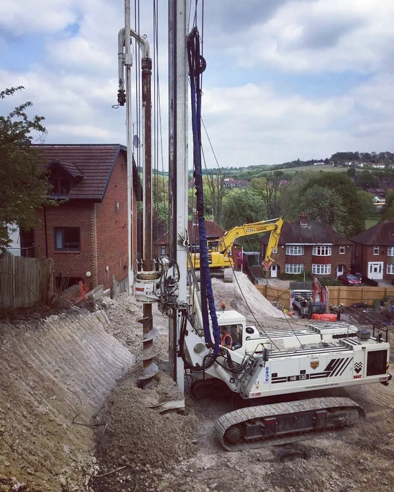 A construction site with a crane and a bulldozer.