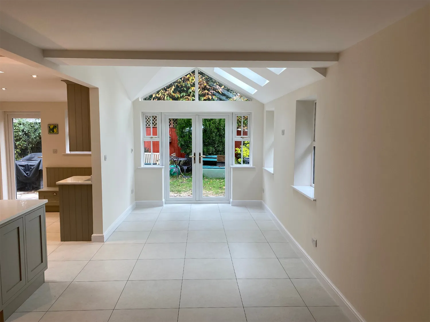 a room with a large window and a tiled floor