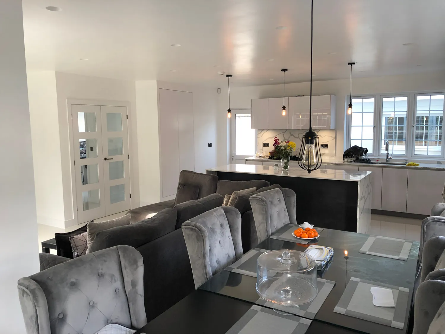 a dining room table with chairs and a glass table