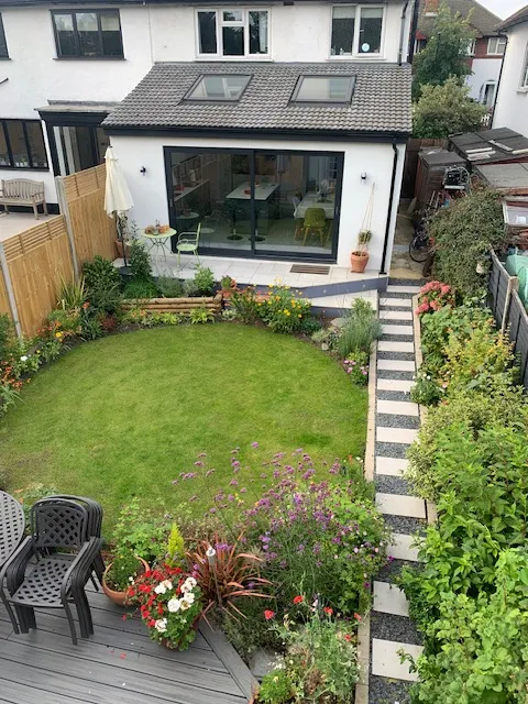 A backyard with a lawn and a deck.