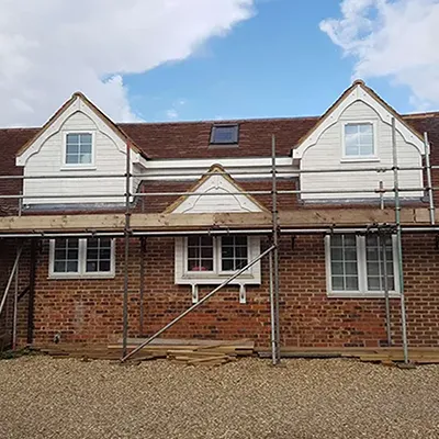 a house under construction with scaffolding around it