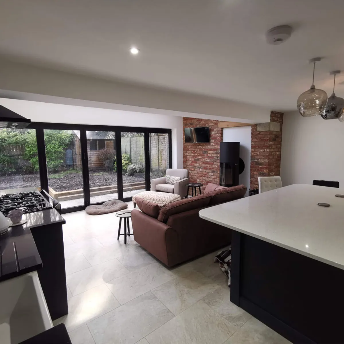 a kitchen and living room with sliding glass doors