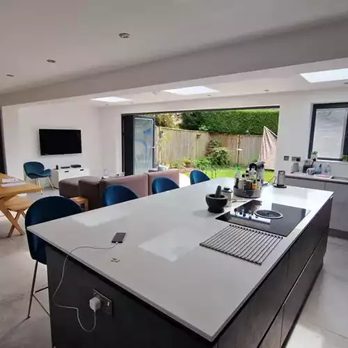 a large kitchen with a center island in the middle of it