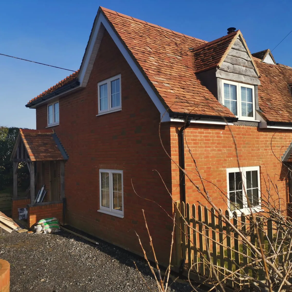 a red brick house with a brown roof