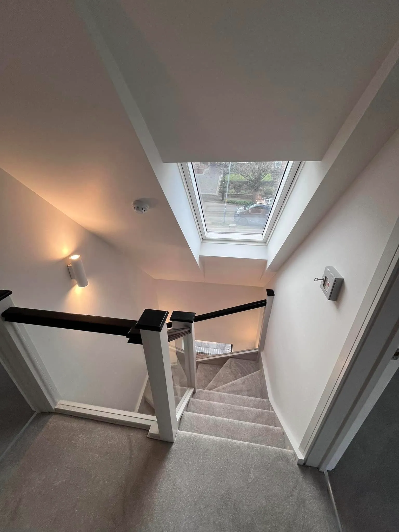 there is a view of a staircase with a skylight above it